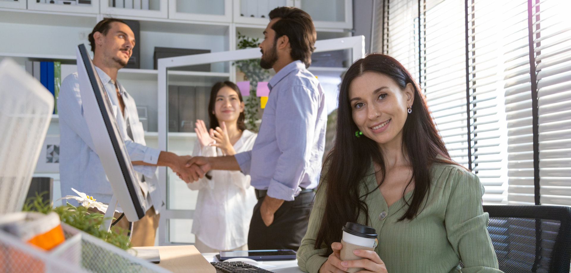 Group of multiethnic young business friends gathered in a modern office conference room