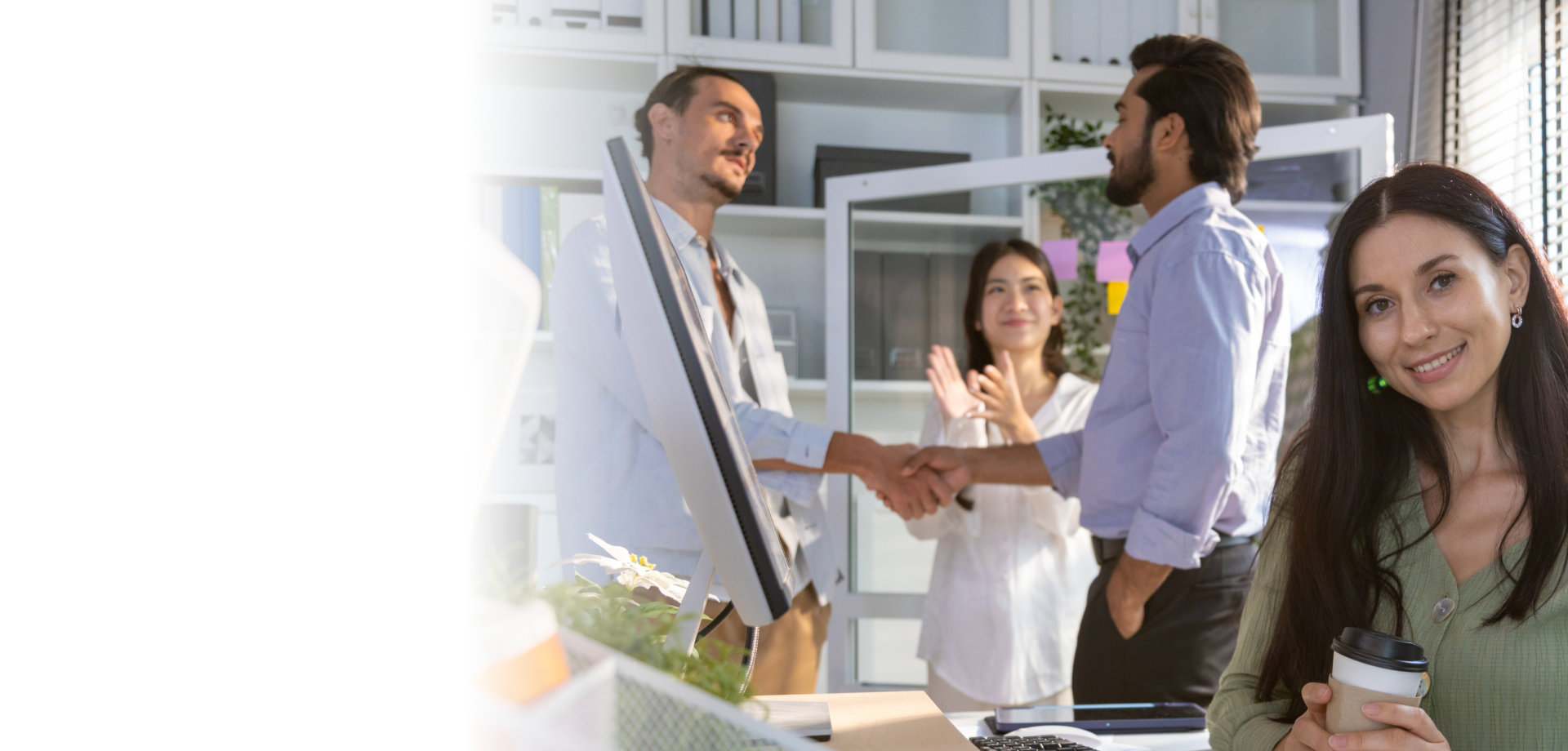 Group of multiethnic young business friends gathered in a modern office conference room