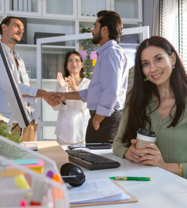 Group of multiethnic young business friends gathered in a modern office conference room